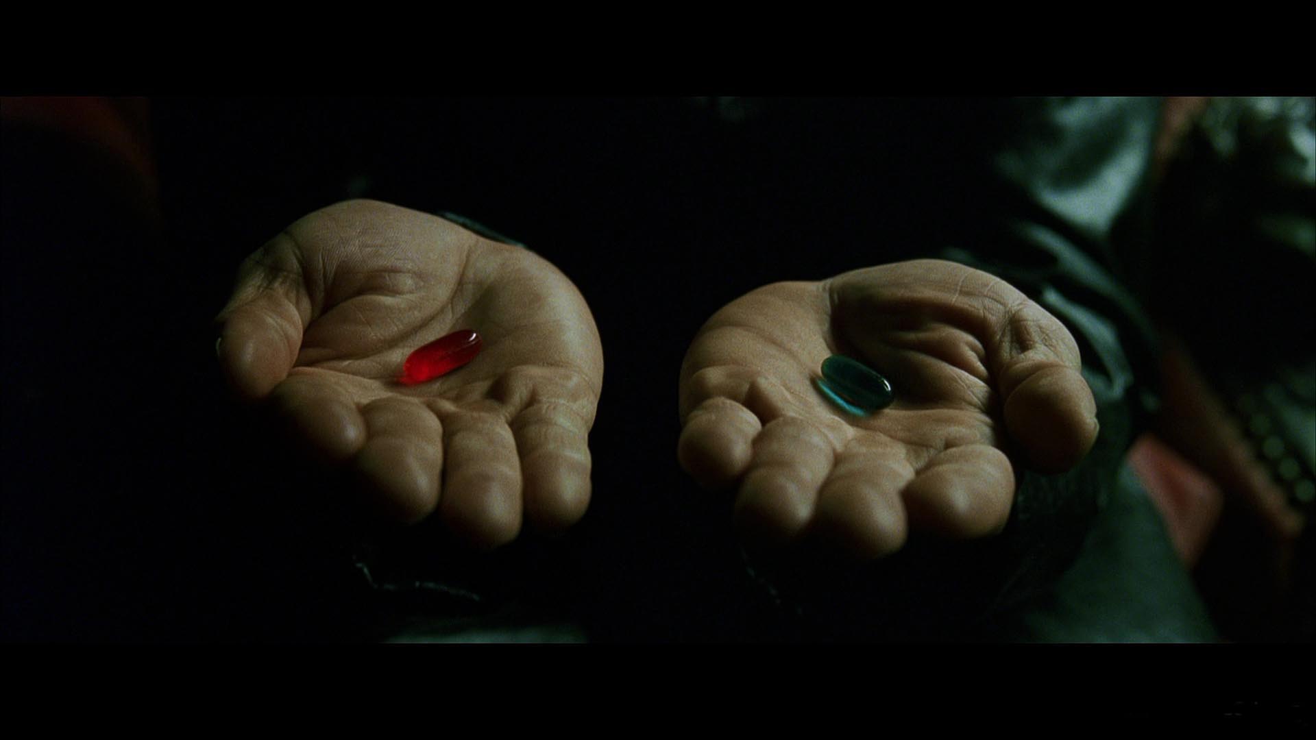 Morpheus’s hands presenting a red pill and a blue pill